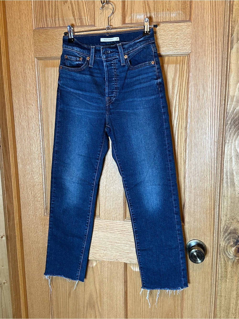 Levi's Wedgie Straight jeans in a dark indigo wash with a raw hem size 25
